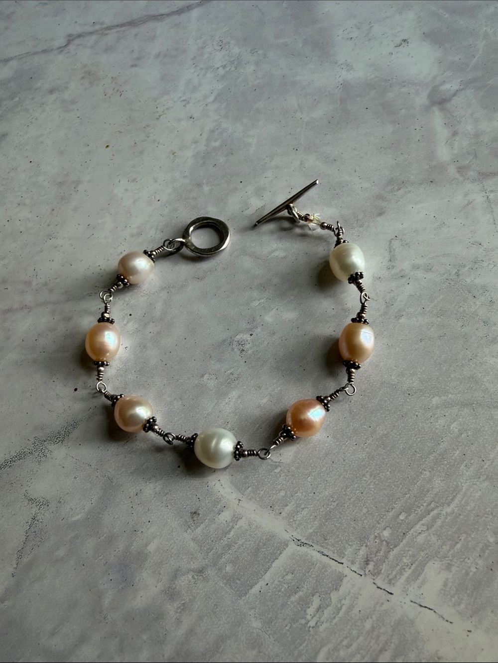 Sterling Silver setting Cultured Pearl Station Bracelet in Cream and Peach.
